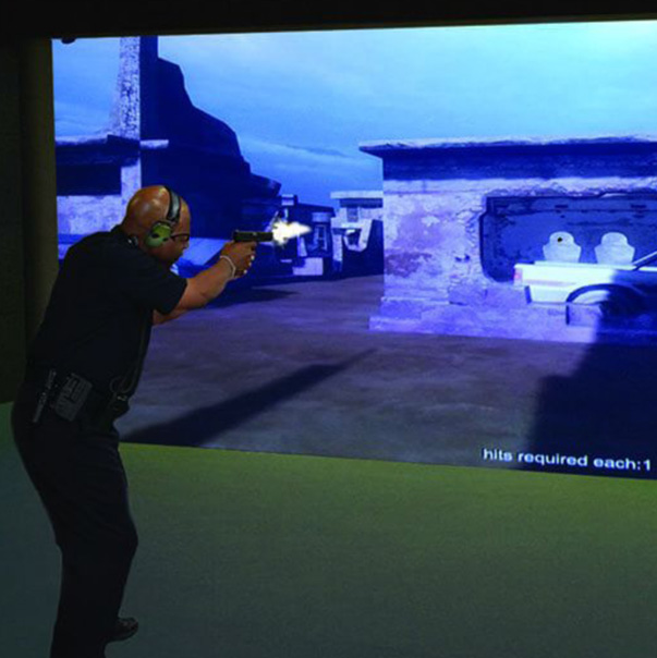 NASTEC security person getting shooting training with video simulation